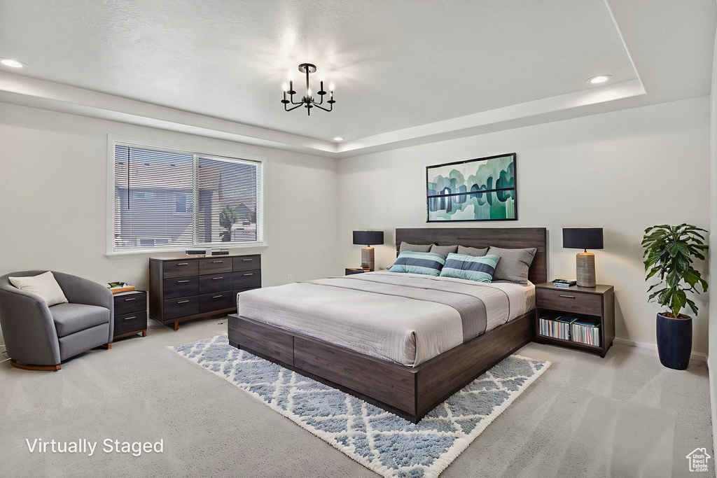 Bedroom featuring light colored carpet, a chandelier, a tray ceiling, and recessed lighting