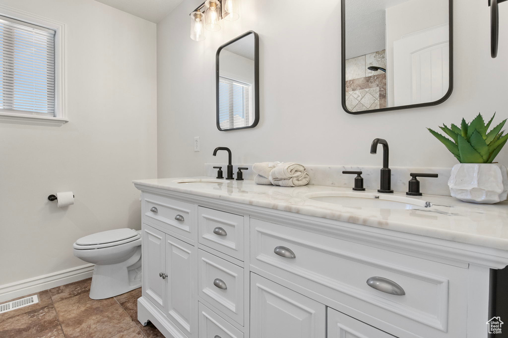 Full bathroom with double vanity and a shower