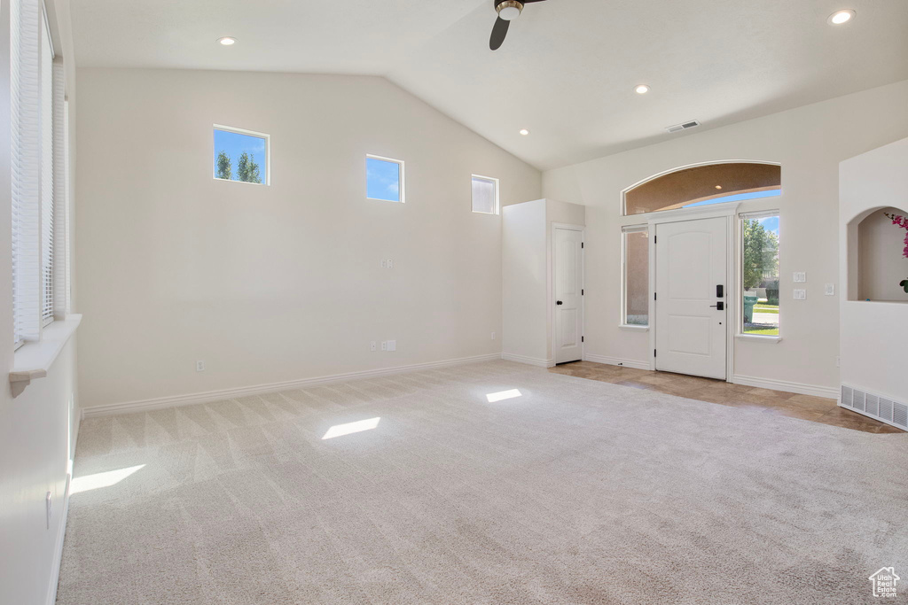 Entrance foyer featuring light carpet, ceiling fan, recessed lighting, and high vaulted ceiling