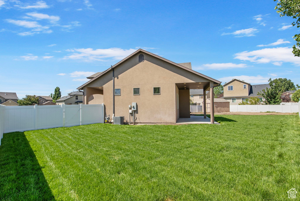 Back of house featuring a patio area, stucco siding, and a fenced backyard