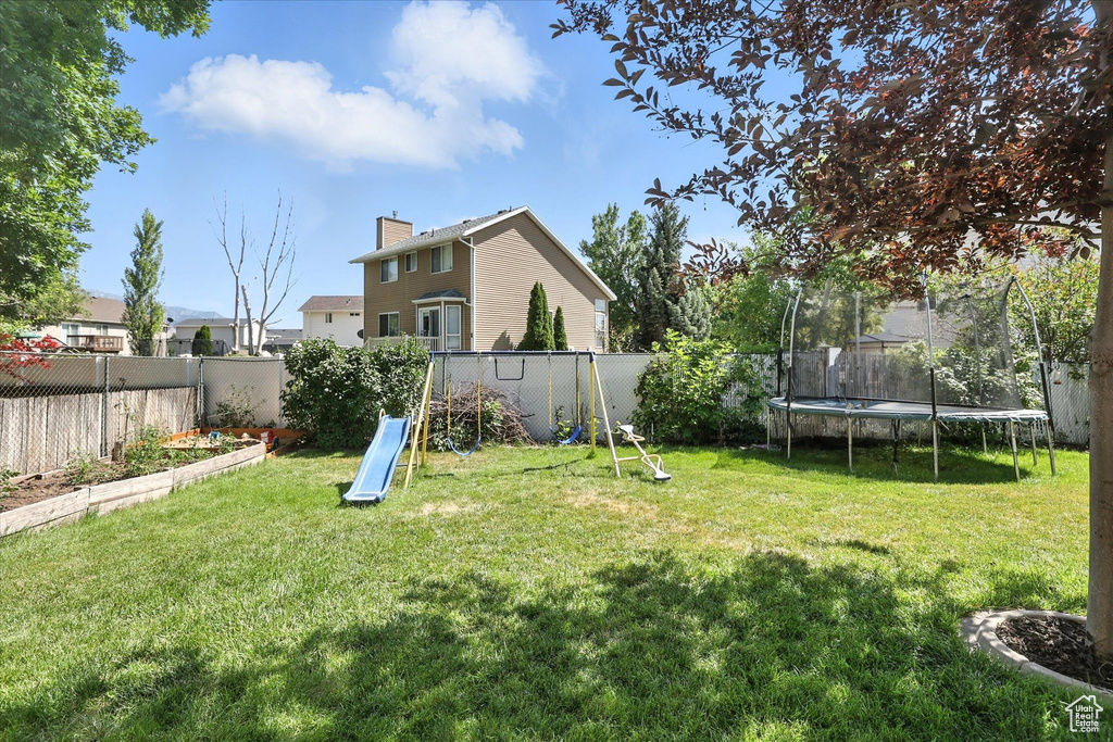 Fenced backyard with a trampoline