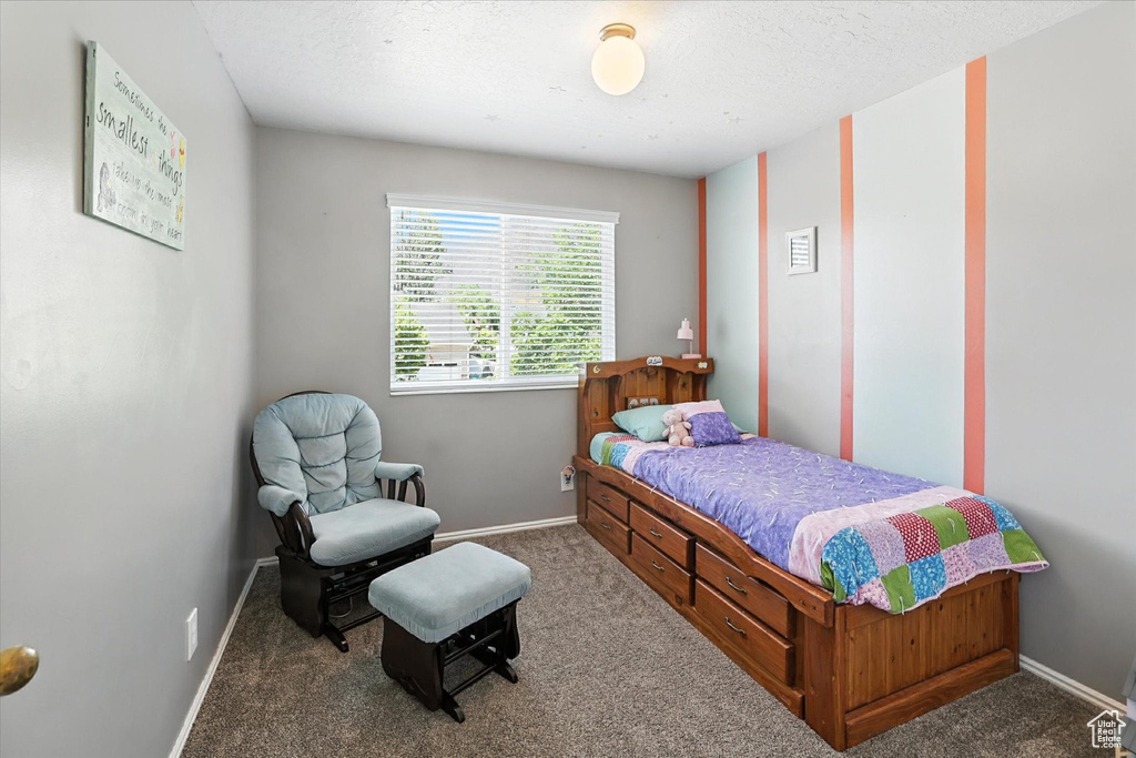 Carpeted bedroom featuring baseboards