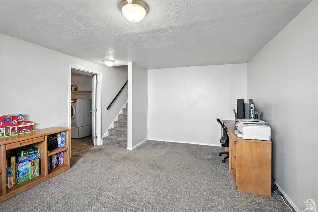 Office featuring washer / dryer, carpet, and a textured ceiling