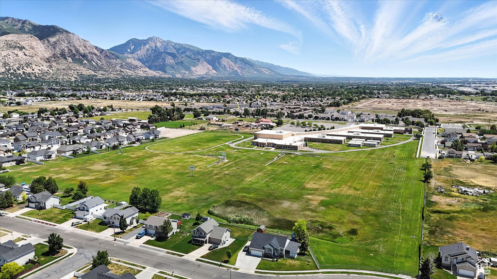Aerial view of property's location featuring mountains and nearby suburban area