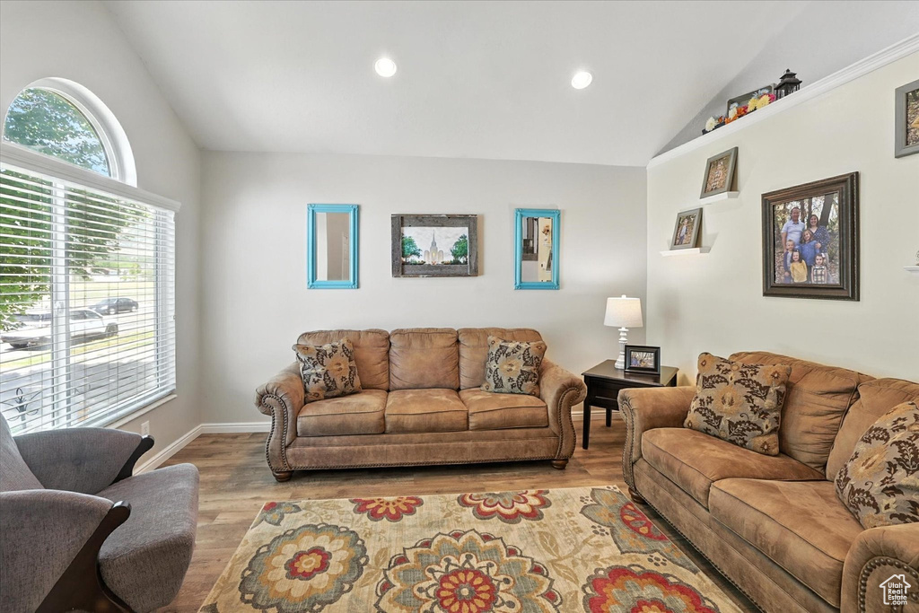 Living area featuring vaulted ceiling, wood finished floors, and recessed lighting