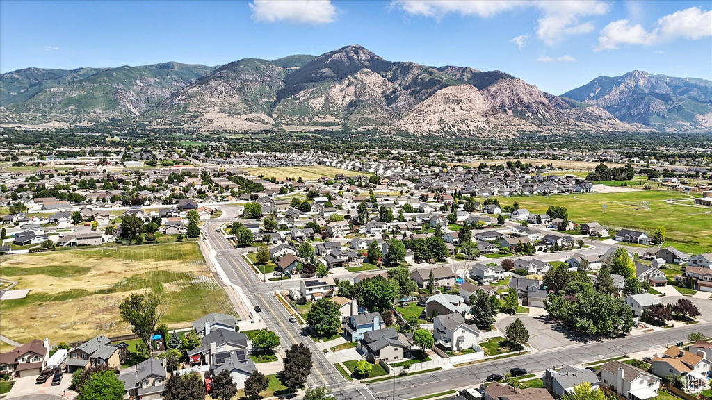 Aerial view of property's location featuring mountains and nearby suburban area