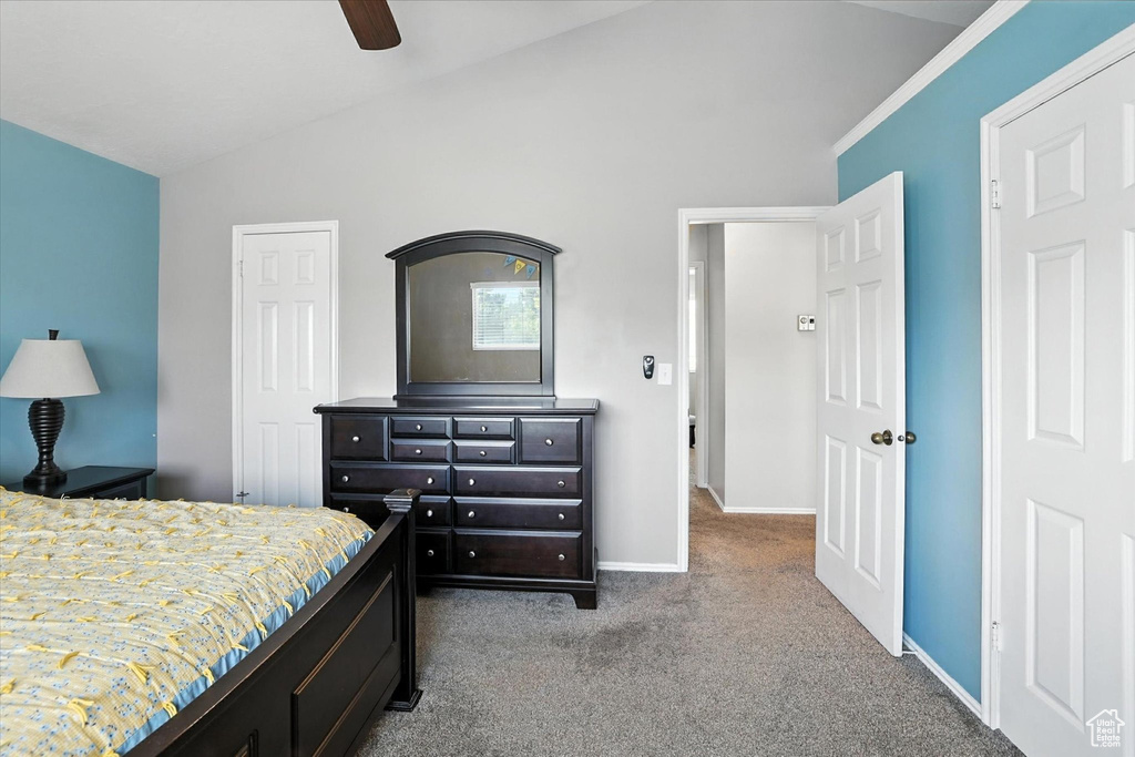 Bedroom with lofted ceiling, carpet floors, and ceiling fan