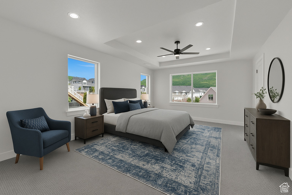 Carpeted bedroom featuring recessed lighting, a raised ceiling, and a ceiling fan