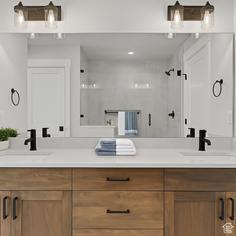Bathroom featuring double vanity and a shower stall