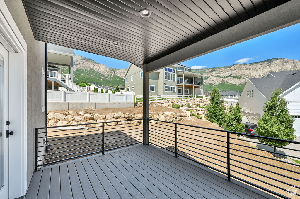 Wooden deck featuring a mountain view and a residential view