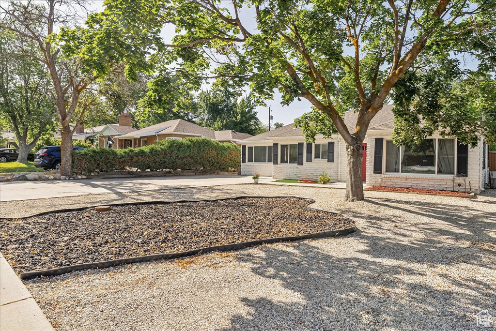 View of front of house with brick siding and concrete driveway