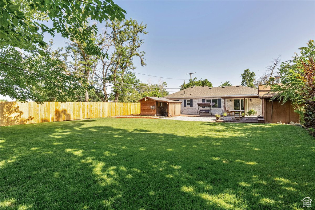 View of yard featuring a patio area and an outbuilding