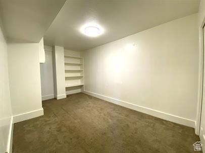 Unfurnished bedroom with dark colored carpet and a closet
