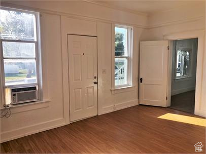 Foyer entrance with dark wood finished floors and cooling unit