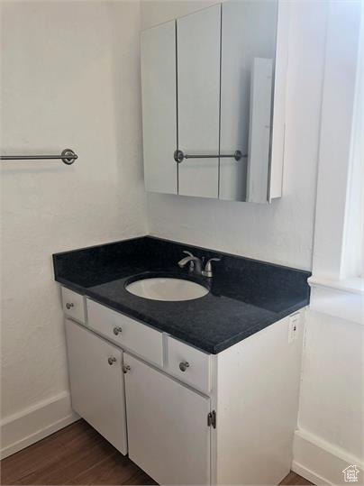 Bathroom with vanity and wood finished floors