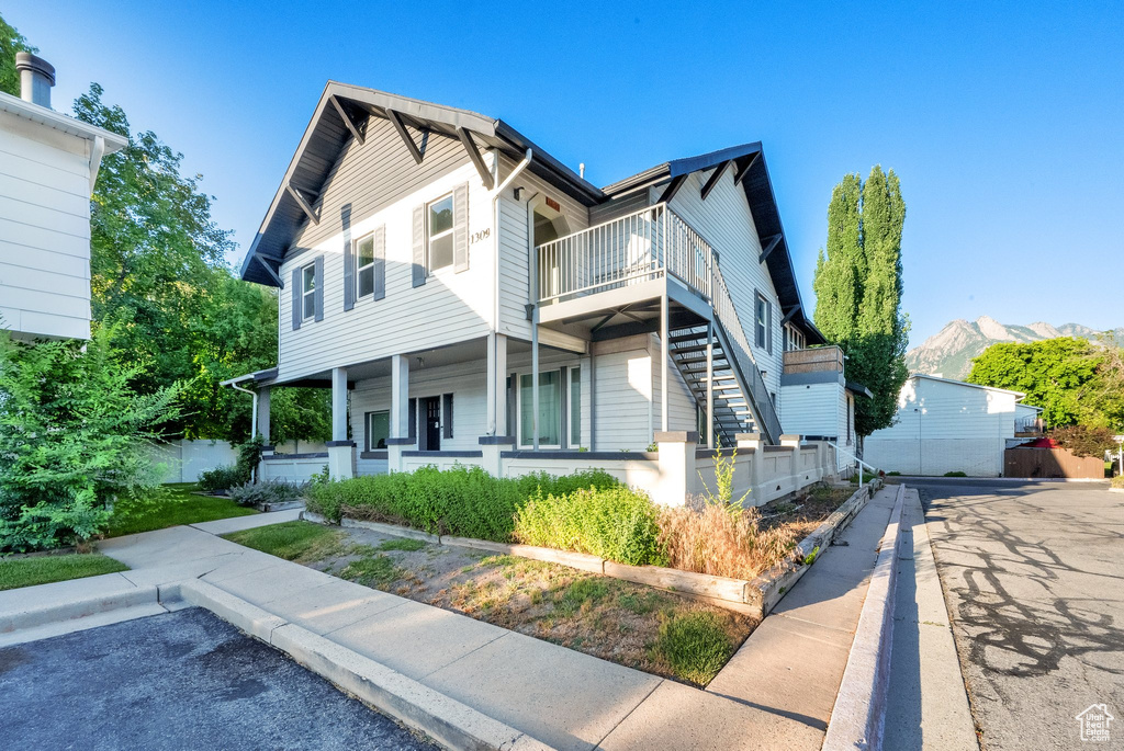 View of front of property with a porch and stairway