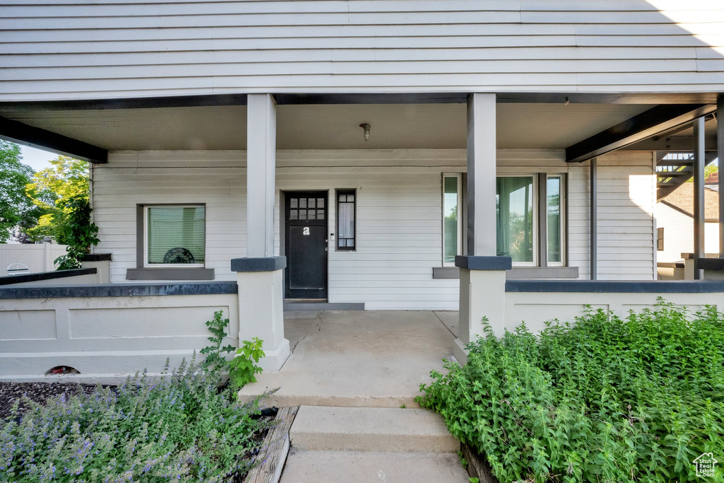 Doorway to property with covered porch