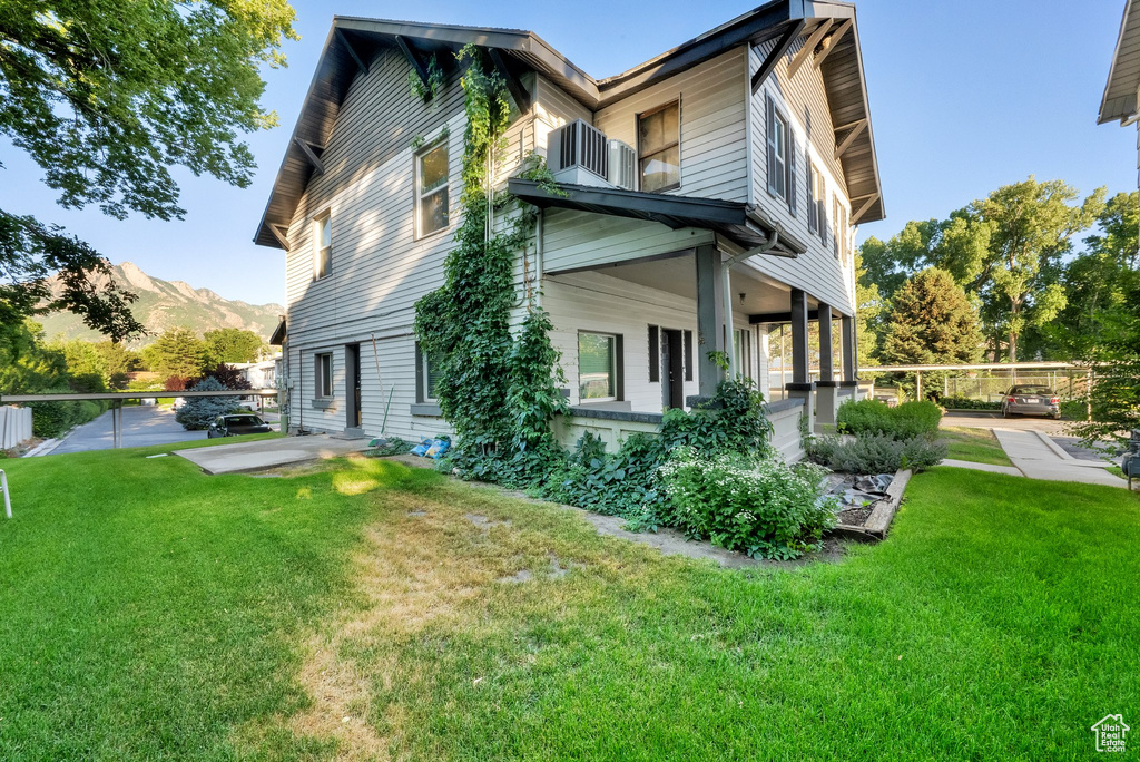 View of side of home with a mountain view