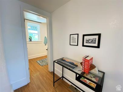 Corridor with wood finished floors and baseboards