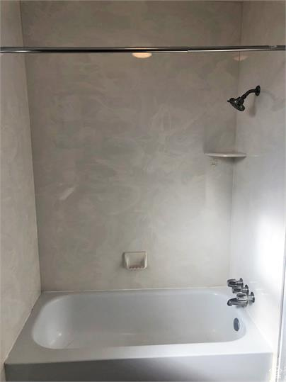 Full bath featuring shower / washtub combination