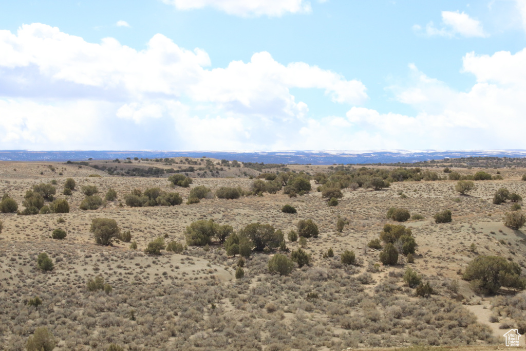View of mountain backdrop with rural landscape