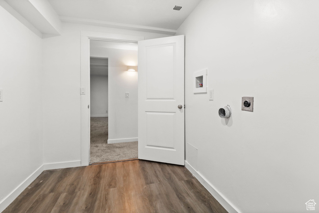 Laundry area with hookup for an electric dryer, washer hookup, and dark wood-style flooring