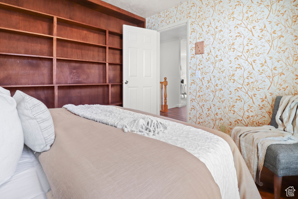 Bedroom featuring wallpapered walls