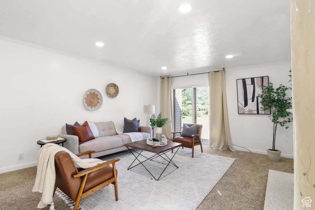 Living room with recessed lighting, light colored carpet, and crown molding