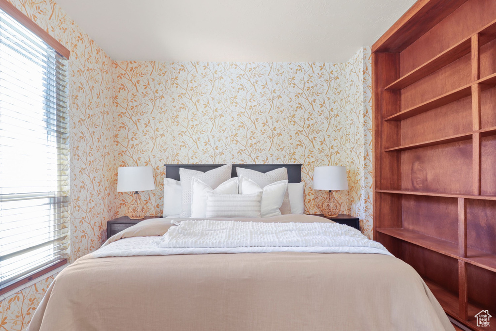 Bedroom featuring wallpapered walls