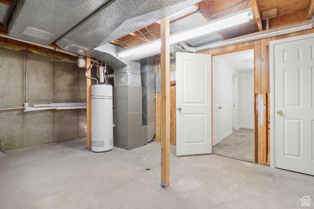Unfinished basement with heating unit and water heater