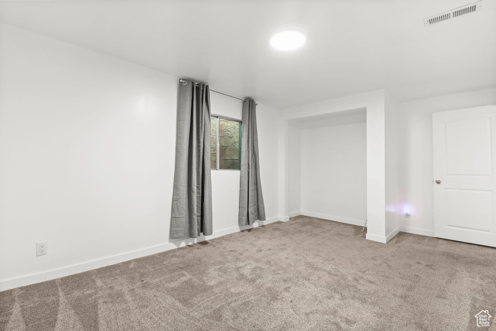 Empty room with carpet flooring and baseboards