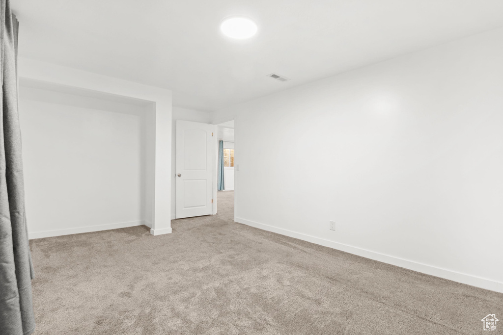 Unfurnished bedroom featuring carpet floors and baseboards
