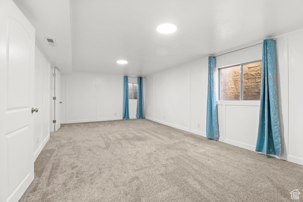 Carpeted spare room with recessed lighting