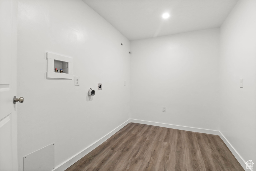 Laundry area featuring electric dryer hookup, washer hookup, and wood finished floors