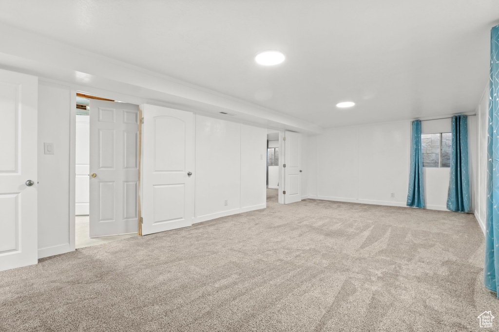 Below grade area with carpet flooring and recessed lighting