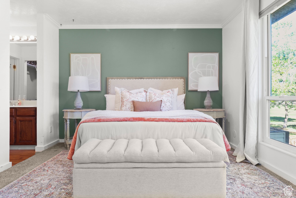 Bedroom with crown molding and ensuite bathroom