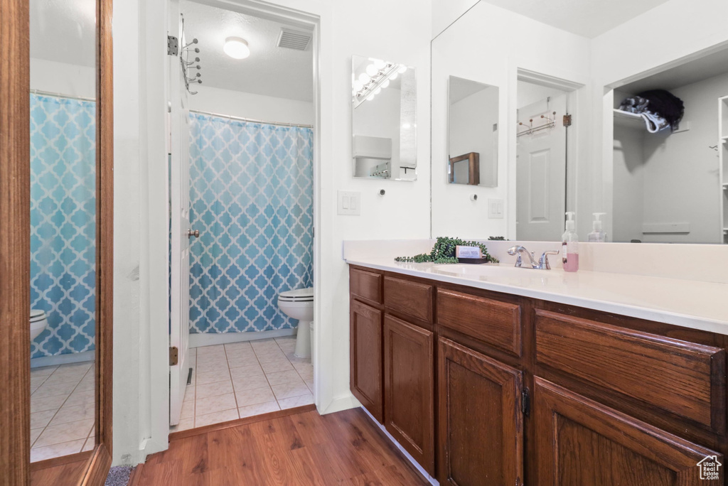 Full bathroom with vanity, tile patterned floors, and a shower with curtain