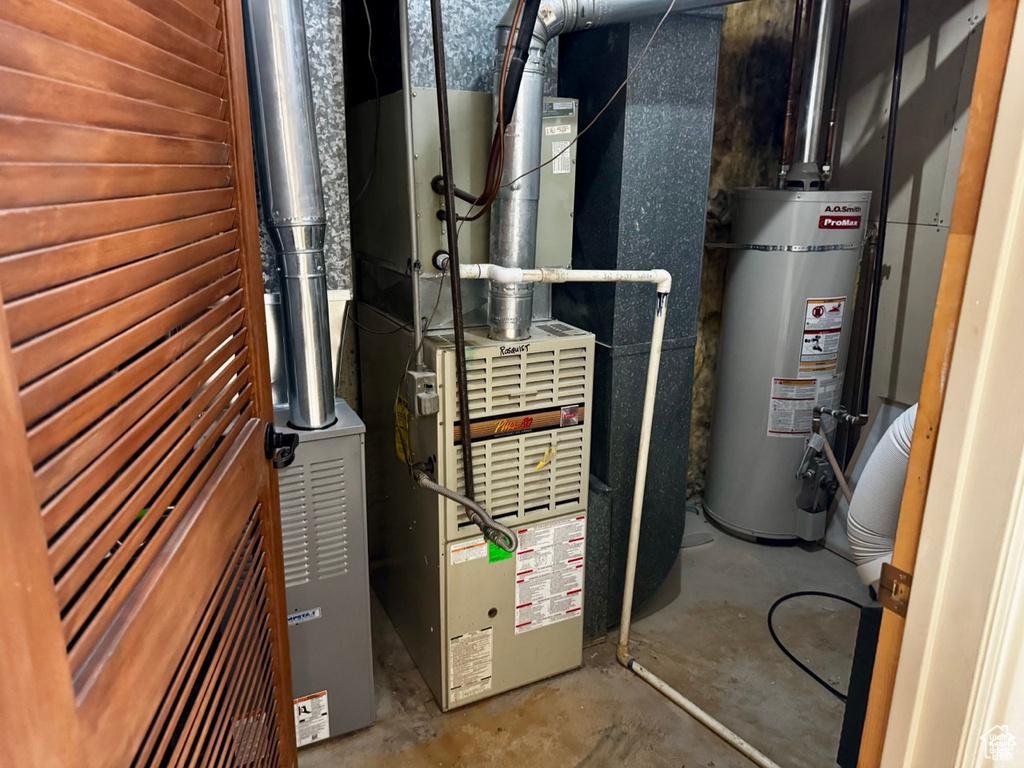 Utility room with strapped water heater and heating unit