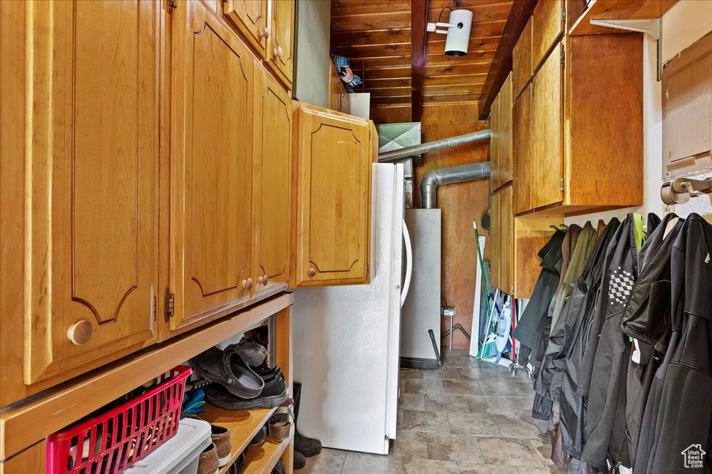 Laundry room with wooden ceiling