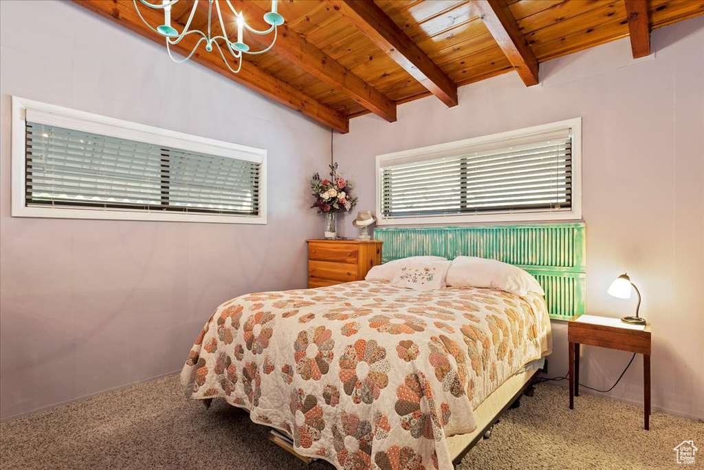 Carpeted bedroom featuring a wood ceiling with exposed beams and a chandelier
