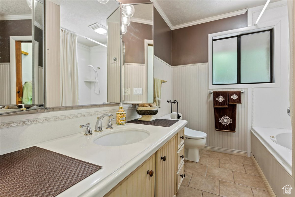 Full bath featuring vanity, a bath, ornamental molding, and a shower with shower curtain