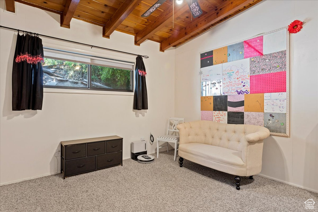 Sitting room featuring a wooden ceiling with exposed beams and carpet floors