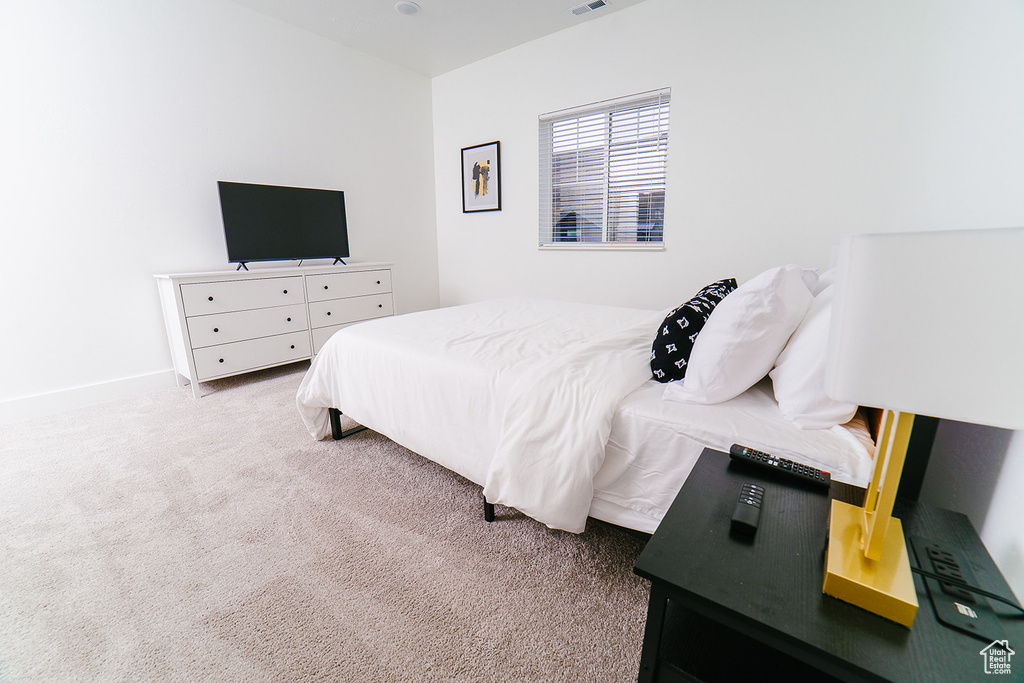 Carpeted bedroom featuring baseboards