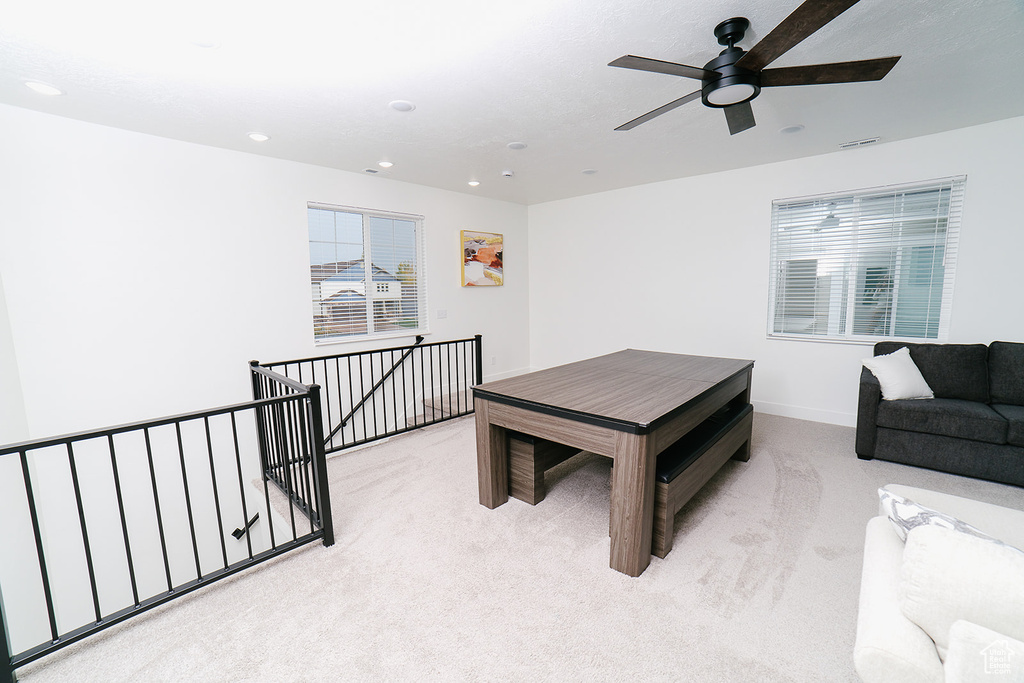 Dining room featuring light colored carpet, ceiling fan, and recessed lighting