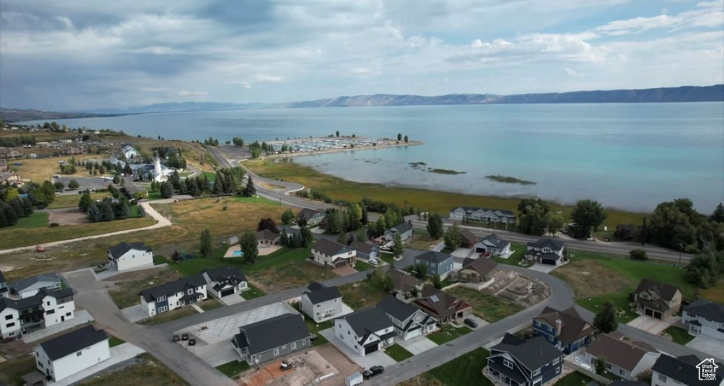 Aerial overview of property's location featuring a large body of water and nearby suburban area
