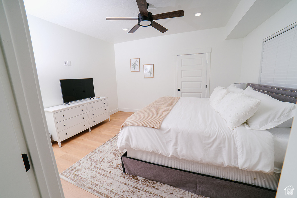 Bedroom with light wood-style flooring, recessed lighting, and ceiling fan