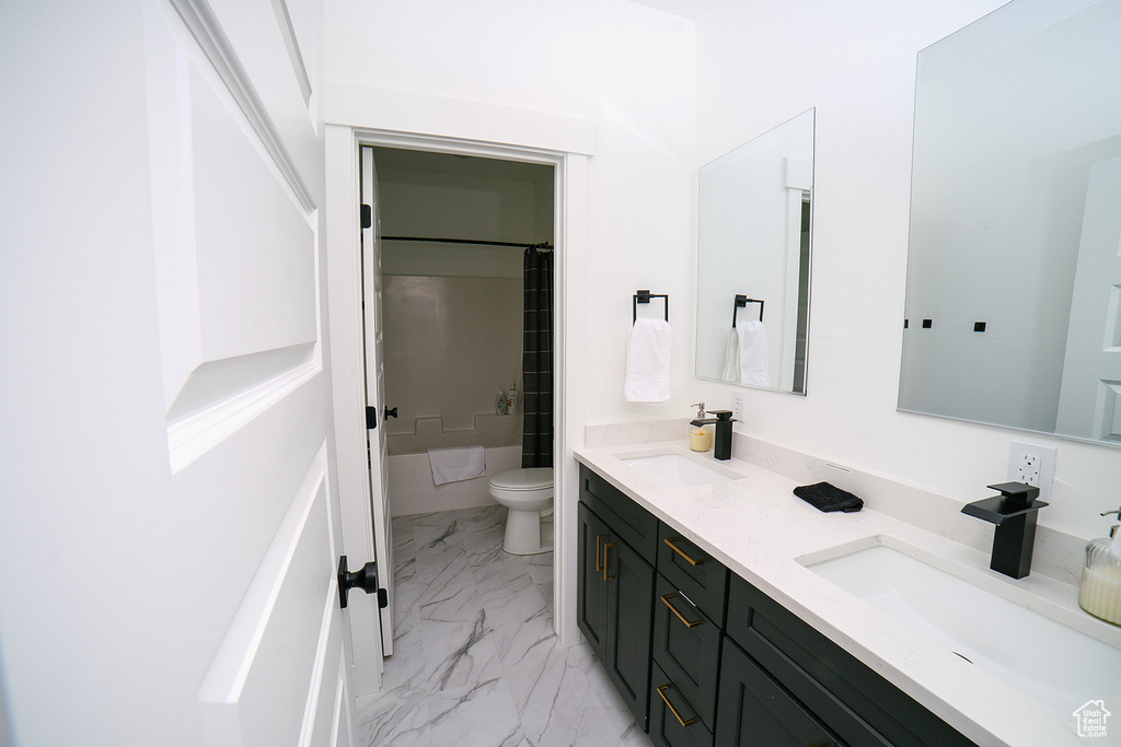Full bath featuring double vanity, marble finish flooring, and shower / bathtub combination with curtain
