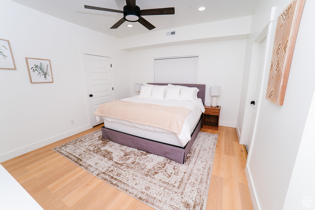 Bedroom with a closet, light wood-style floors, recessed lighting, and a ceiling fan