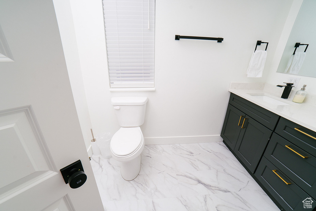 Bathroom featuring marble finish flooring and vanity