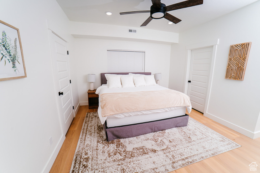 Bedroom with light wood finished floors, recessed lighting, and a ceiling fan